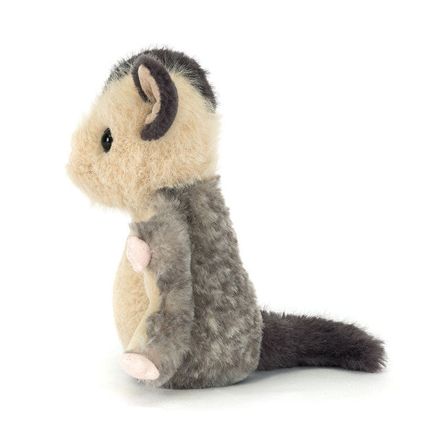 The Jellycat Lolly Sugar Glider by Jellycat is a plush toy with beige and gray fur, pink ears, and a fluffy dark gray tail, resembling a sugar glider and shown in profile against a white background.